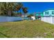 Large yard with mature trees, seating, and white fencing for privacy at 519 Mobile Ave, Daytona Beach, FL 32118
