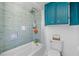 Updated bathroom features a shower/tub combo, modern fixtures, and stylish teal accent tile at 519 Mobile Ave, Daytona Beach, FL 32118