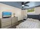 Bedroom with ceiling fan, dresser with TV and a comfortable bed at 519 Mobile Ave, Daytona Beach, FL 32118