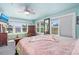 Bright bedroom with large windows, ceiling fan, and colorful decorative elements at 519 Mobile Ave, Daytona Beach, FL 32118