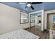 Bedroom featuring ceiling fan, window with AC, and mirrored closet at 519 Mobile Ave, Daytona Beach, FL 32118
