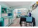 Inviting dining area with turquoise accents, tile floors, and decorative serving hutch at 519 Mobile Ave, Daytona Beach, FL 32118