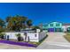 Charming two-story coastal home with colorful exterior, white fencing, and mature landscaping at 519 Mobile Ave, Daytona Beach, FL 32118