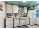 Functional kitchen with stove, refrigerator, and built-in cabinets at 519 Mobile Ave, Daytona Beach, FL 32118