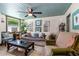 Comfortable living room with large sofa, ceiling fan, and decorative art at 519 Mobile Ave, Daytona Beach, FL 32118