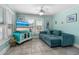 Inviting living room featuring a comfortable sectional sofa, tile floors and a decorative entertainment center at 519 Mobile Ave, Daytona Beach, FL 32118