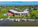 Beautiful aerial view featuring a waterfront condo complex with a pool, docks, and lush landscaping at 520 S Peninsula Ave # 2C7, New Smyrna Beach, FL 32169