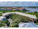 Stunning aerial view showcasing the condo building, lush greenery, and water views at 520 S Peninsula Ave # 2C7, New Smyrna Beach, FL 32169