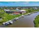 Aerial view of condo complex overlooking boat docks and surrounding waterways at 520 S Peninsula Ave # 2C7, New Smyrna Beach, FL 32169