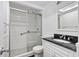 Updated bathroom featuring a glass-enclosed shower, white vanity, and modern fixtures at 520 S Peninsula Ave # 2C7, New Smyrna Beach, FL 32169