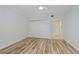 Bright bedroom with a ceiling fan, a double-door closet, wood look floors and fresh paint at 520 S Peninsula Ave # 2C7, New Smyrna Beach, FL 32169