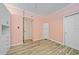 Cozy bedroom features wood-look tile floors, built-in cabinets and neutral paint at 520 S Peninsula Ave # 2C7, New Smyrna Beach, FL 32169