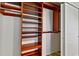 Walk-in closet features custom wooden shelving and storage solutions at 520 S Peninsula Ave # 2C7, New Smyrna Beach, FL 32169