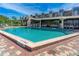 Resort-style pool surrounded by lounge chairs and lush landscaping, perfect for relaxation and recreation at 520 S Peninsula Ave # 2C7, New Smyrna Beach, FL 32169