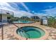Community hot tub near pool with brick paver decking, and views of nearby buildings at 520 S Peninsula Ave # 2C7, New Smyrna Beach, FL 32169