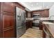 Chef's kitchen with stainless steel appliances and cherry wood cabinets, plus a tile backsplash at 520 S Peninsula Ave # 2C7, New Smyrna Beach, FL 32169