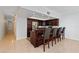 Modern kitchen bar with granite countertops, stainless steel appliances, and adjacent hallway entrance at 520 S Peninsula Ave # 2C7, New Smyrna Beach, FL 32169