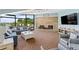 Spacious living room featuring a stone fireplace, ample seating, and scenic views at 520 S Peninsula Ave # 2C7, New Smyrna Beach, FL 32169