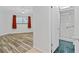 Spacious main bedroom with wood-look floors, walk-in shower, and natural light at 520 S Peninsula Ave # 2C7, New Smyrna Beach, FL 32169