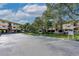 Expansive parking area with designated parking spots in front of a well-maintained complex and landscaping at 520 S Peninsula Ave # 2C7, New Smyrna Beach, FL 32169