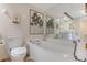 Elegant bathroom with a soaking tub, decorative mirror, and stylish fixtures for a luxurious experience at 533 Marina Point Dr # 533, Daytona Beach, FL 32114