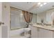 Well-maintained bathroom with a shower-tub combo with sliding doors, granite countertop, and neutral tile flooring at 533 Marina Point Dr # 533, Daytona Beach, FL 32114