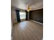 Cozy bedroom with laminate flooring, neutral paint, window view, and ceiling fan at 533 Marina Point Dr # 533, Daytona Beach, FL 32114