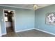 Bedroom showcasing ensuite bathroom, wood flooring, ceiling fan, and a decorative painting at 533 Marina Point Dr # 533, Daytona Beach, FL 32114