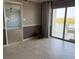Bright living room with tile floors, access to the balcony, and neutral wall paint at 533 Marina Point Dr # 533, Daytona Beach, FL 32114
