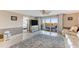 Bright living room with sliding glass doors to the balcony and elegant neutral décor at 533 Marina Point Dr # 533, Daytona Beach, FL 32114