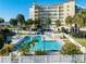 Community pool with crystal clear water, surrounded by lush tropical landscaping and lounge chairs at 533 Marina Point Dr # 533, Daytona Beach, FL 32114