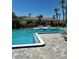 Inviting pool with brick surround, blue umbrellas, and lounge chairs for relaxation by the home at 533 Marina Point Dr # 533, Daytona Beach, FL 32114
