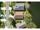 Aerial view of a home situated on a street near a tranquil lake at 549 Coral Trace Blvd, Edgewater, FL 32132