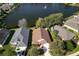 A beautiful home with a well-manicured lawn, a fountain in the pond, and mature trees providing shade at 549 Coral Trace Blvd, Edgewater, FL 32132