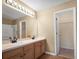Bathroom featuring dual sinks, vanity, and a separate shower and closet at 549 Coral Trace Blvd, Edgewater, FL 32132
