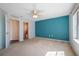 Well-lit bedroom with a walk-in closet and plush carpeting at 549 Coral Trace Blvd, Edgewater, FL 32132