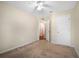 This bedroom offers neutral walls, carpet flooring, and entry to the hallway at 549 Coral Trace Blvd, Edgewater, FL 32132