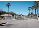 The gated entrance to Coral Trace community, showcasing palm trees and lush landscaping at 549 Coral Trace Blvd, Edgewater, FL 32132