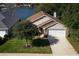This exterior view showcases a charming home, front yard, and mature landscaping at 549 Coral Trace Blvd, Edgewater, FL 32132
