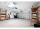 This garage features storage shelves, speckled flooring, and an automatic door at 549 Coral Trace Blvd, Edgewater, FL 32132