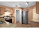 Kitchen featuring granite countertops, stainless steel appliances, pantry, and tile floors at 549 Coral Trace Blvd, Edgewater, FL 32132