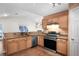 Kitchen featuring granite countertops, stainless steel appliances, light wood cabinets, and tile floors at 549 Coral Trace Blvd, Edgewater, FL 32132