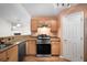 Kitchen featuring granite countertops, stainless steel appliances, light wood cabinets, and tile floors at 549 Coral Trace Blvd, Edgewater, FL 32132