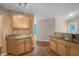 Kitchen featuring granite countertops, light wood cabinets, and tile floors at 549 Coral Trace Blvd, Edgewater, FL 32132