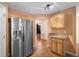 Kitchen featuring granite countertops, stainless steel appliances, light wood cabinets, and tile floors at 549 Coral Trace Blvd, Edgewater, FL 32132