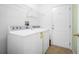 This laundry room comes complete with a washer, dryer, and wire shelf at 549 Coral Trace Blvd, Edgewater, FL 32132