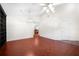 Bright living room featuring beautiful hardwood floors, a ceiling fan, and an open layout at 549 Coral Trace Blvd, Edgewater, FL 32132