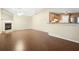 Bright living room with hardwood floors, fireplace, and seamless flow to kitchen at 549 Coral Trace Blvd, Edgewater, FL 32132