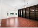 Inviting living room with hardwood floors, a wall of windows, and a built-in bookshelf at 549 Coral Trace Blvd, Edgewater, FL 32132