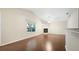 Living room with hardwood floors, vaulted ceiling, and fireplace at 549 Coral Trace Blvd, Edgewater, FL 32132